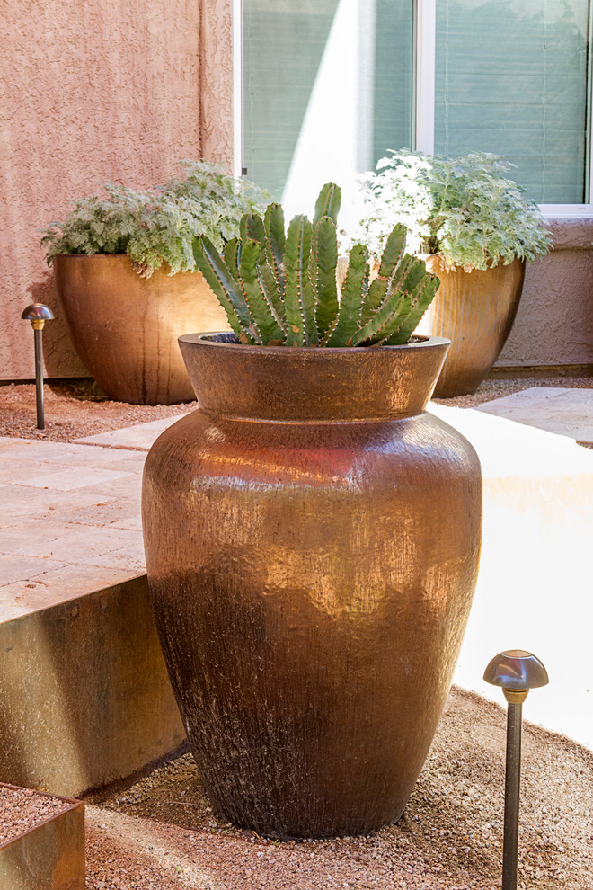 Inspiration for a small modern back xeriscape partial sun garden in Phoenix with natural stone paving.