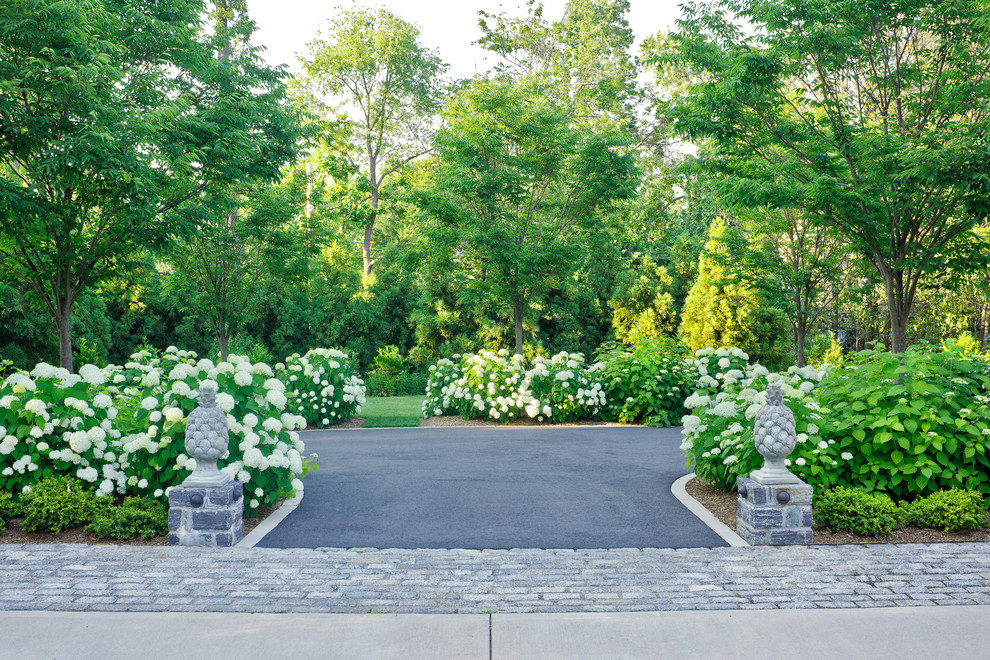 Design ideas for an expansive classic front driveway fully shaded garden in DC Metro with a flowerbed.