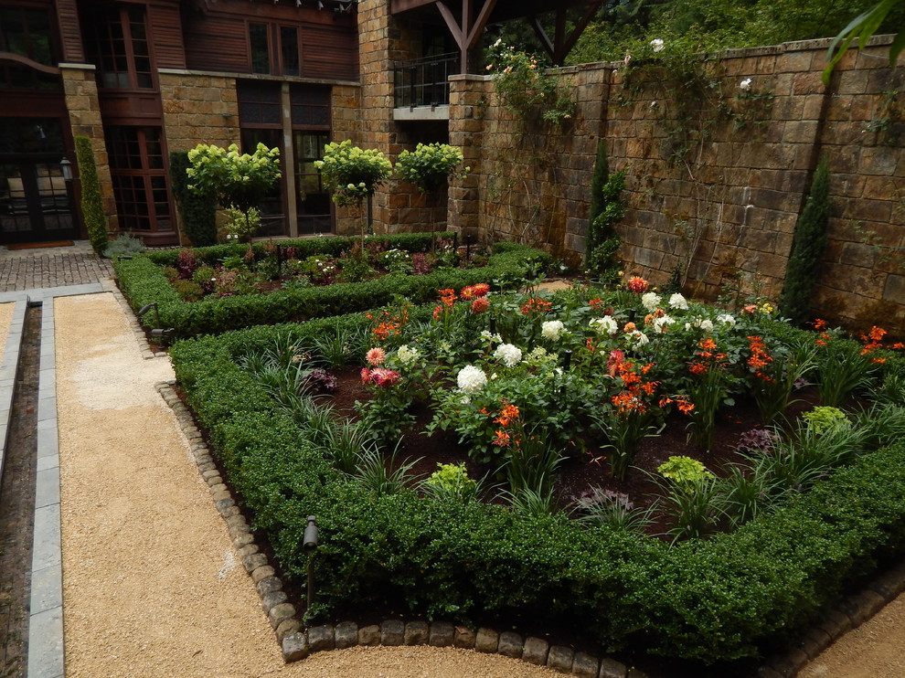 This is an example of a medium sized traditional courtyard formal partial sun garden for summer in Seattle with gravel.