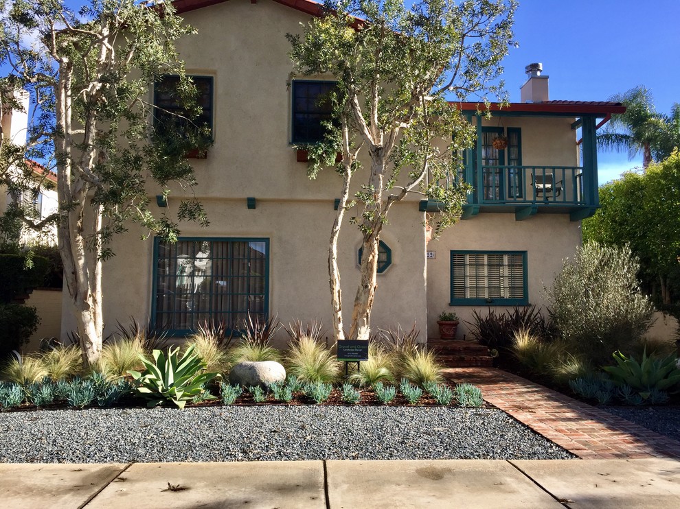 Photo of a mid-sized mediterranean drought-tolerant and full sun front yard brick landscaping in Los Angeles.