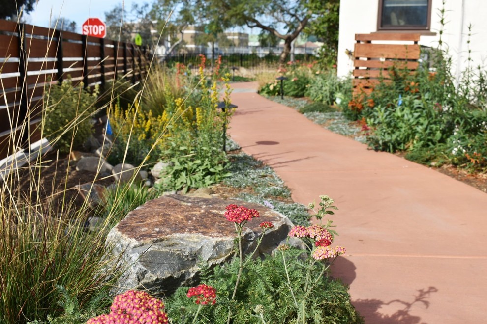 This is an example of a small southwestern drought-tolerant and full sun side yard concrete paver garden path in San Diego.