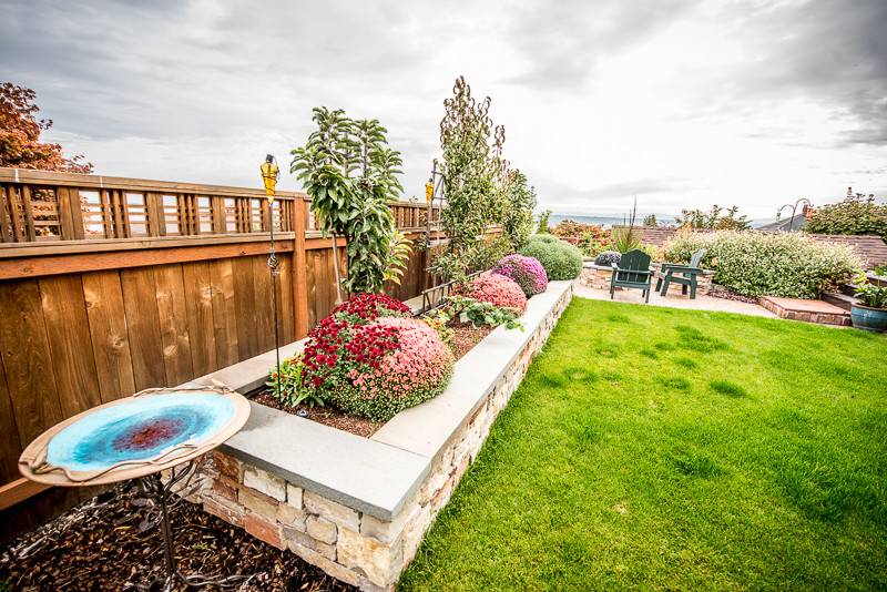Design ideas for a mid-sized craftsman backyard stone vegetable garden landscape in Seattle.