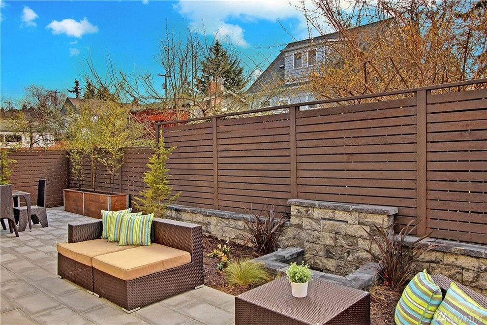 Photo of a small contemporary back patio in Seattle with a water feature and concrete paving.