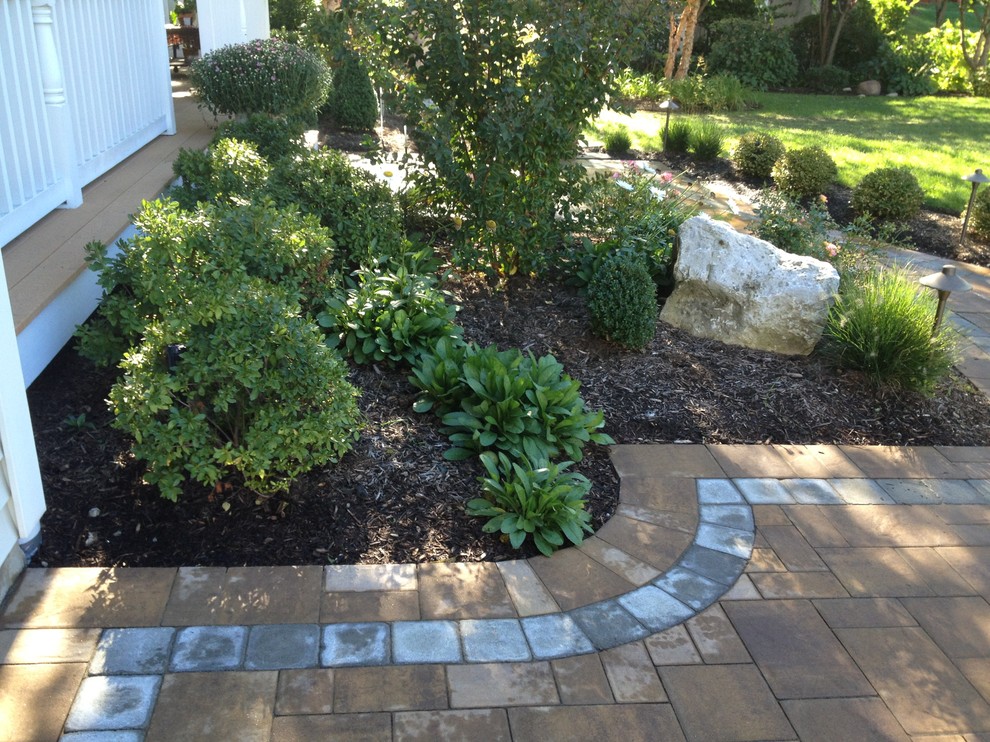 Inspiration for a traditional front driveway garden in New York with concrete paving.