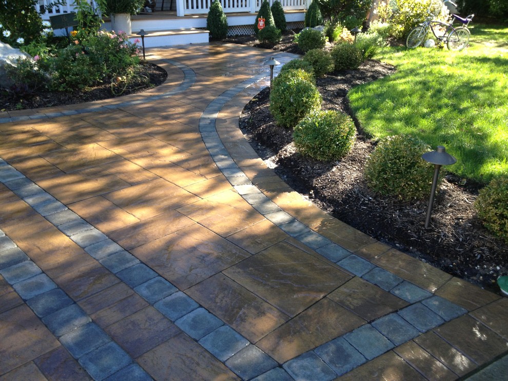 This is an example of a classic front driveway garden in New York with concrete paving.