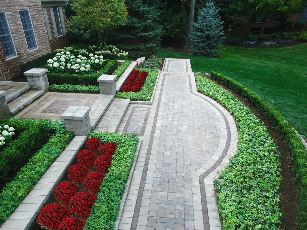 This is an example of a large traditional partial sun front yard brick driveway in Detroit for spring.
