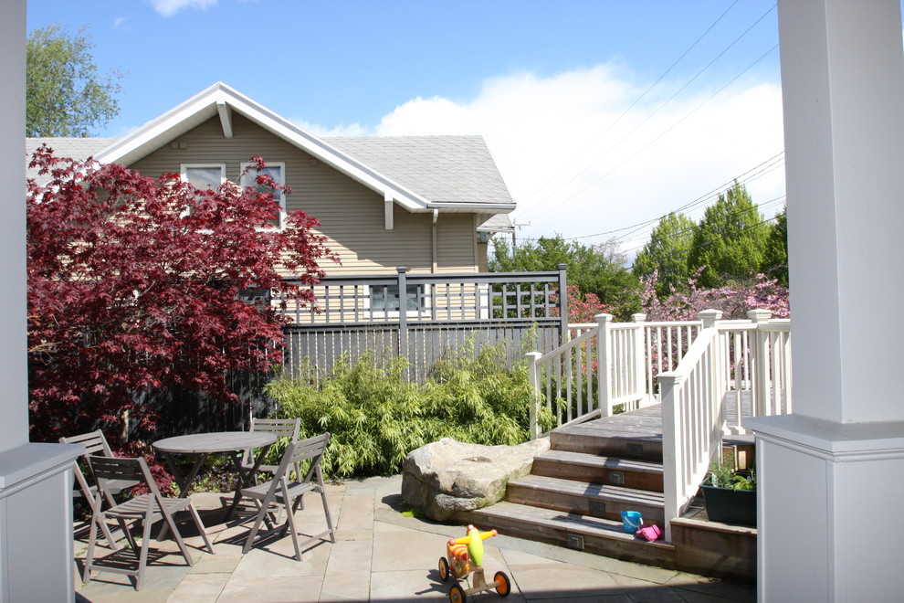 Photo of a small classic back formal partial sun garden in Seattle with a gate and natural stone paving.