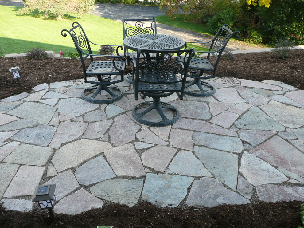 This is an example of a mid-sized contemporary shade backyard stone garden path in Milwaukee.