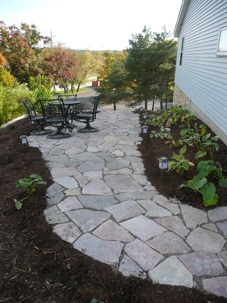 Inspiration for a medium sized contemporary back fully shaded garden in Milwaukee with a garden path and natural stone paving.