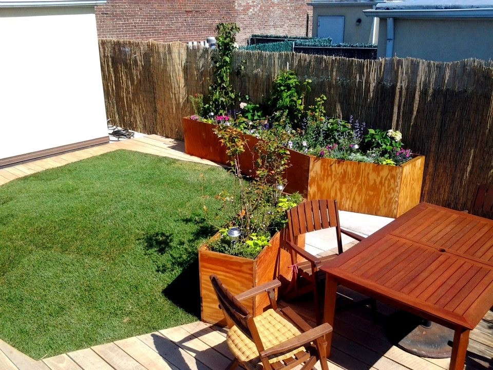 This is an example of a medium sized eclectic roof partial sun garden for spring in New York with a potted garden and decking.