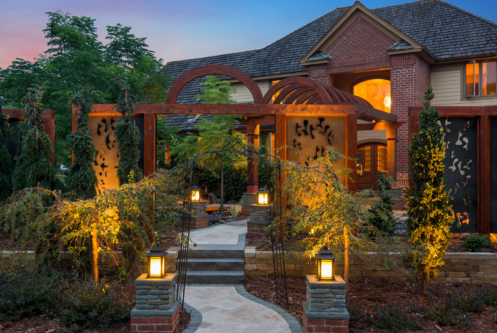 This is an example of a world-inspired front garden in Minneapolis with natural stone paving.