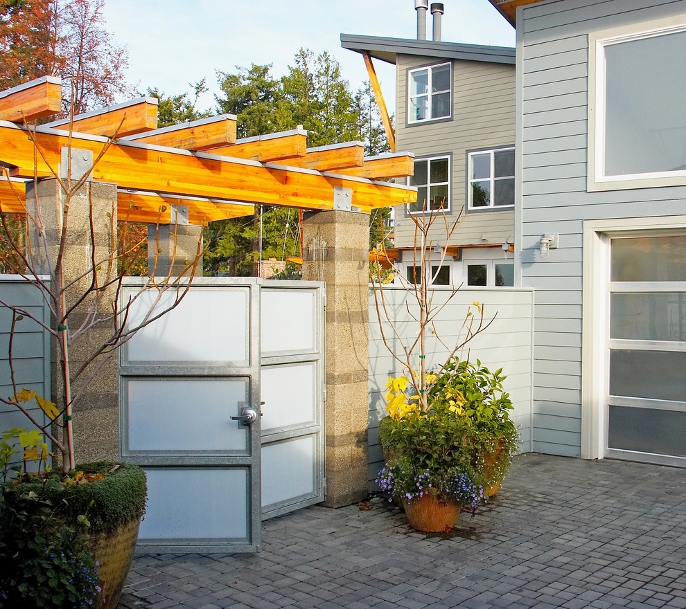 Diseño de jardín de secano contemporáneo de tamaño medio en verano en patio delantero con adoquines de hormigón y exposición parcial al sol