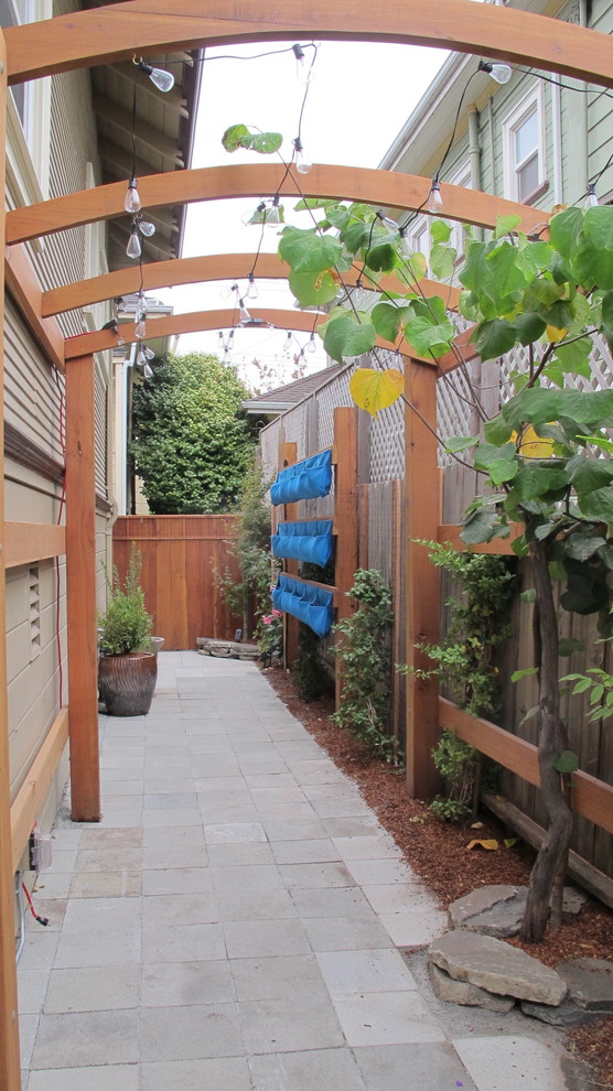 This is an example of a medium sized classic side partial sun garden in San Francisco.