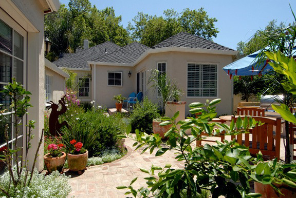 This is an example of a mid-sized contemporary full sun backyard brick garden path in Sacramento for summer.