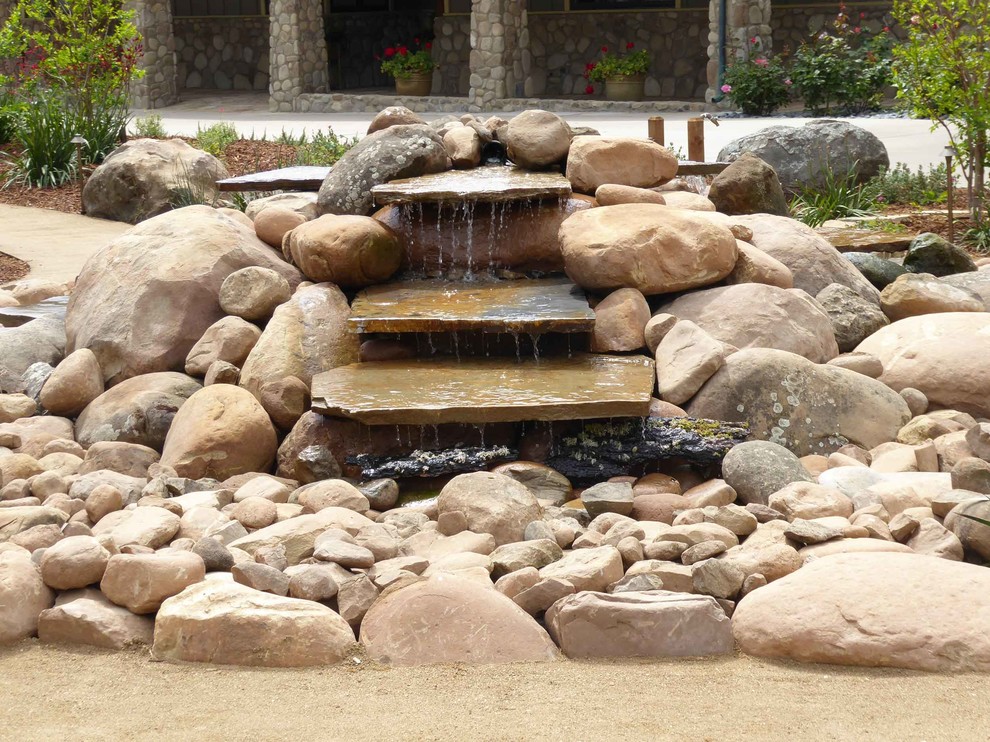 Design ideas for a large traditional drought-tolerant and partial sun front yard mulch water fountain landscape in Santa Barbara for summer.