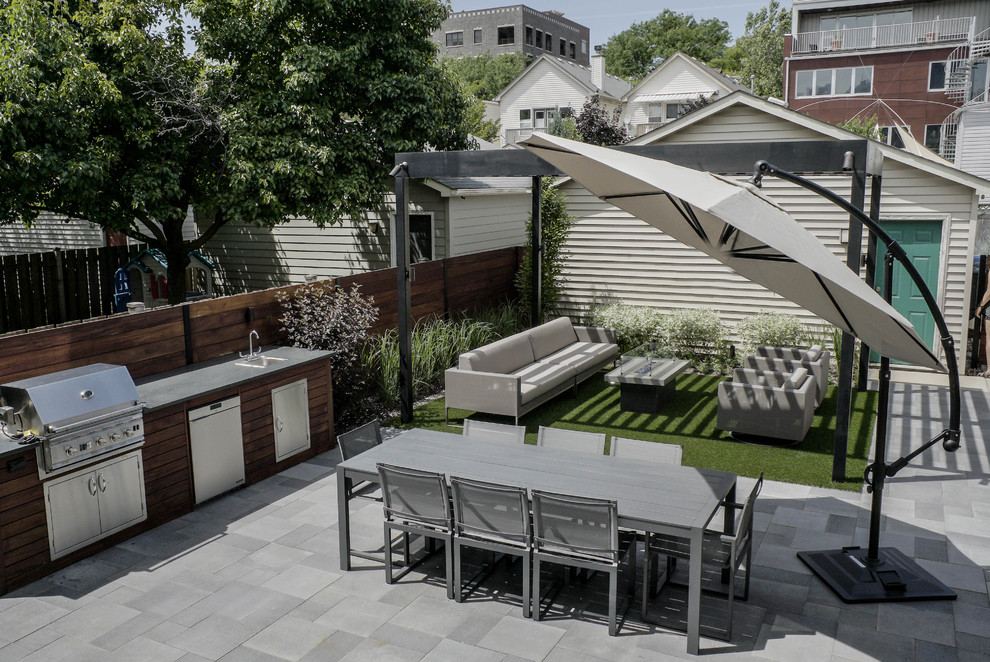 Foto de jardín minimalista de tamaño medio en verano en patio trasero con brasero, exposición parcial al sol y adoquines de hormigón