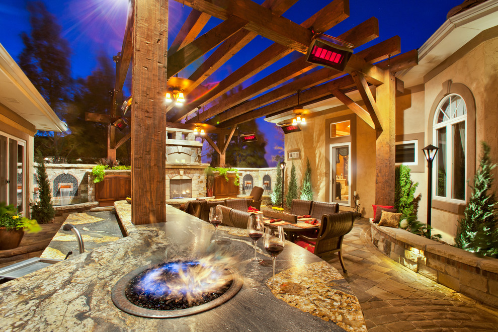 Patio - large mediterranean courtyard concrete paver patio idea in Denver with a fire pit