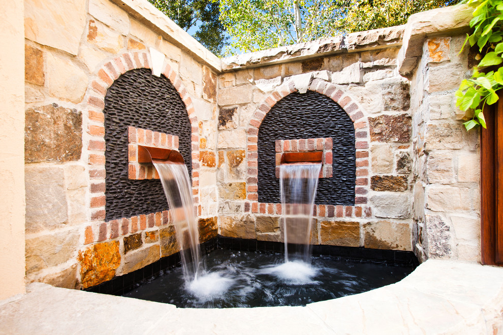 Medium sized mediterranean courtyard fully shaded garden in Denver with a water feature.