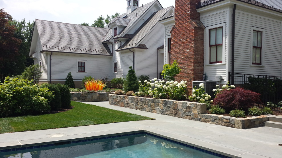 This is an example of a large traditional side yard gravel garden path in New York for summer.