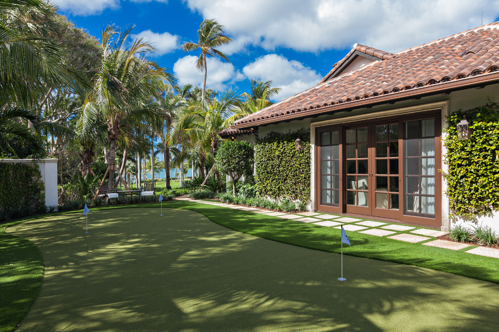 Photo of a mediterranean back garden in Miami with an outdoor sport court.