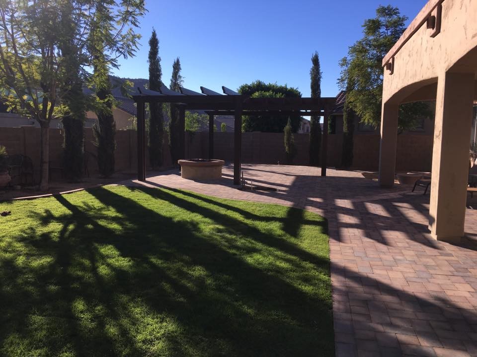 Inspiration for a large rustic back formal fully shaded garden for summer in Phoenix with a fire feature and natural stone paving.