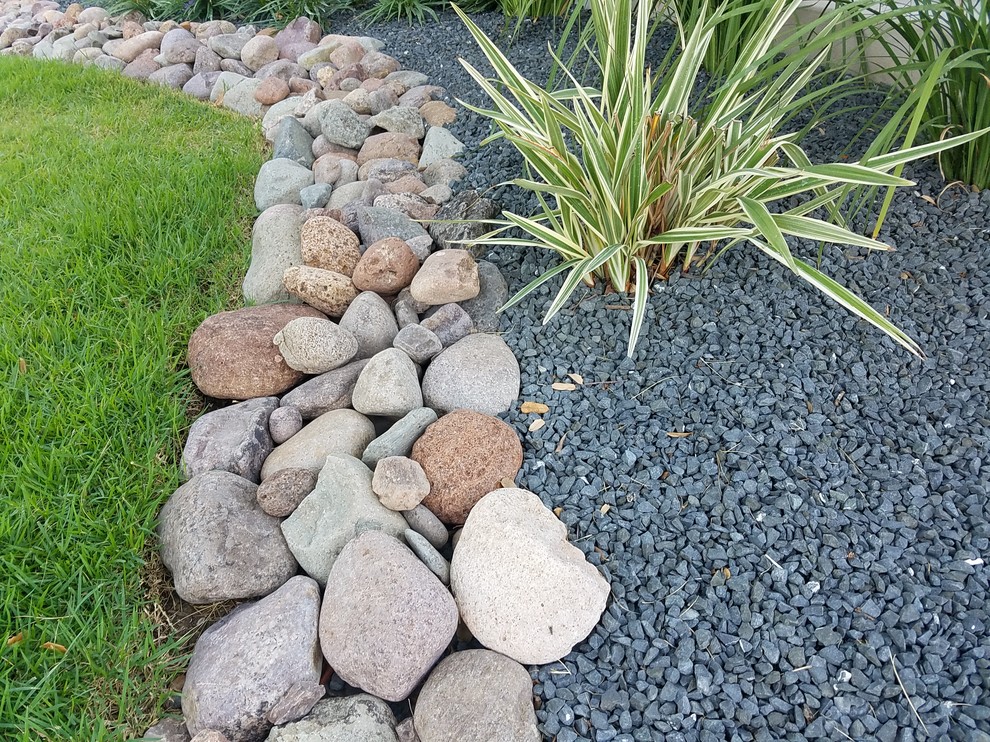 Design ideas for a medium sized world-inspired front xeriscape full sun garden for summer in Other with a garden path and natural stone paving.