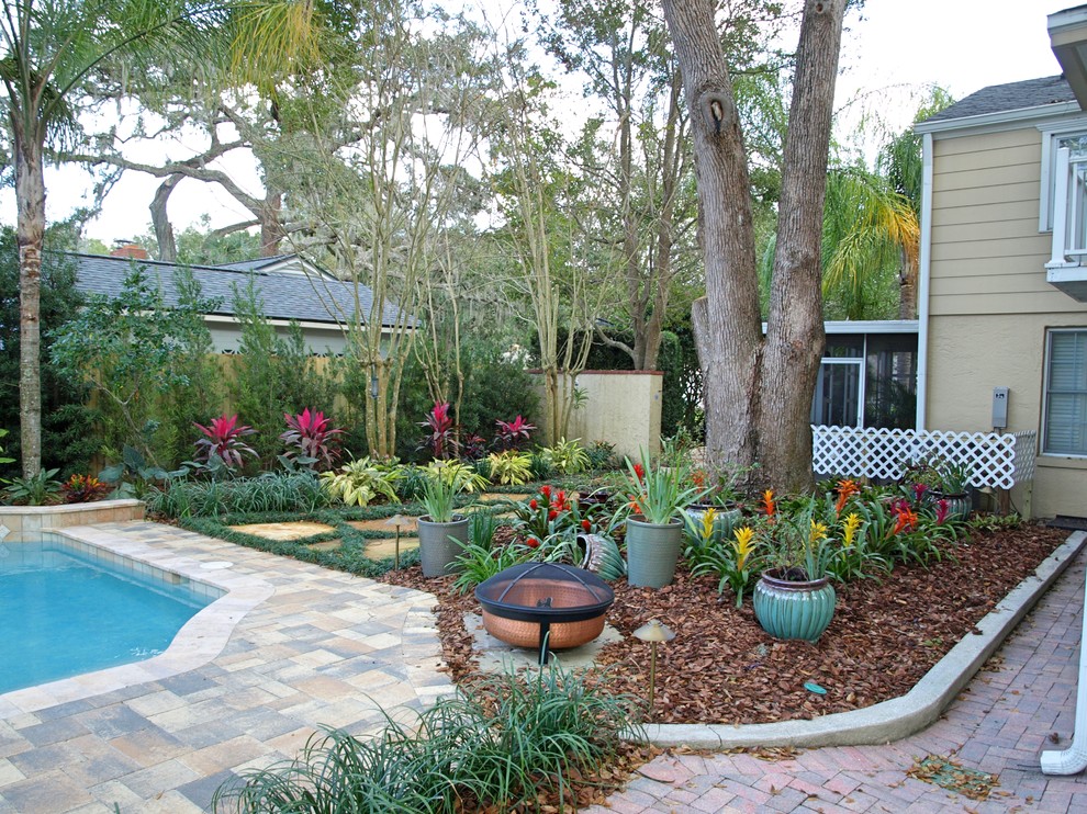 Photo of a small contemporary shade backyard stone landscaping in Orlando for summer.