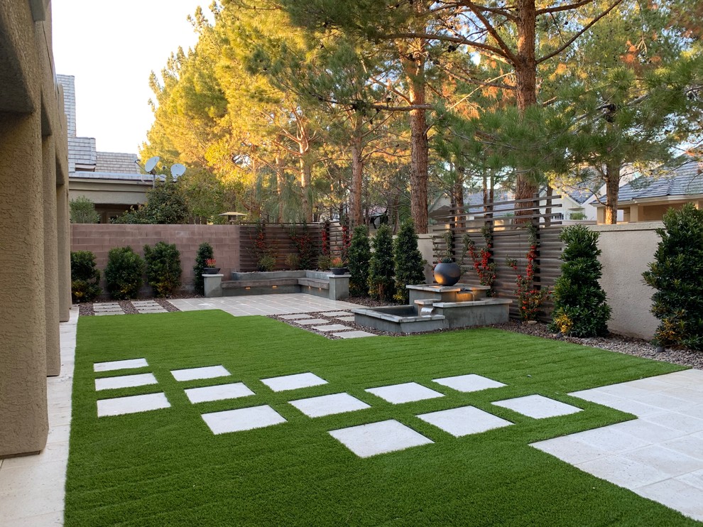 Medium sized modern back xeriscape partial sun garden in Las Vegas with concrete paving.