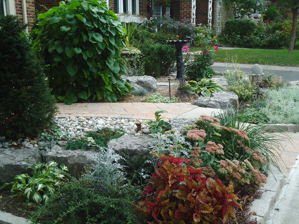 Inspiration for a medium sized classic front driveway full sun garden for spring in Toronto with a garden path and brick paving.