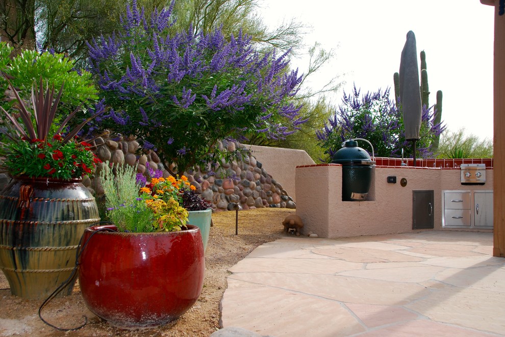 Immagine di un grande giardino stile americano esposto a mezz'ombra dietro casa con pavimentazioni in pietra naturale