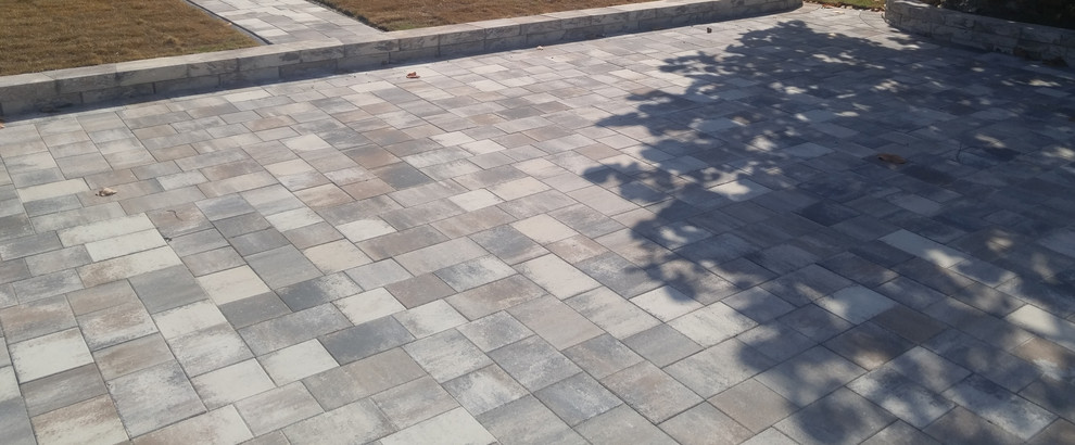 This is an example of a mid-sized traditional partial sun concrete paver landscaping in Tampa.
