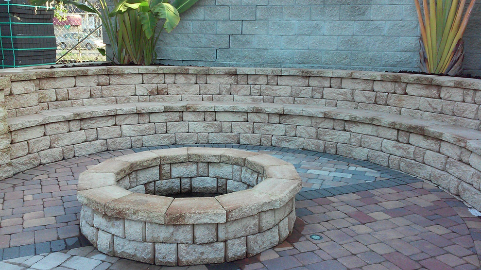 Inspiration for a medium sized classic back partial sun garden in Tampa with a fire feature and concrete paving.