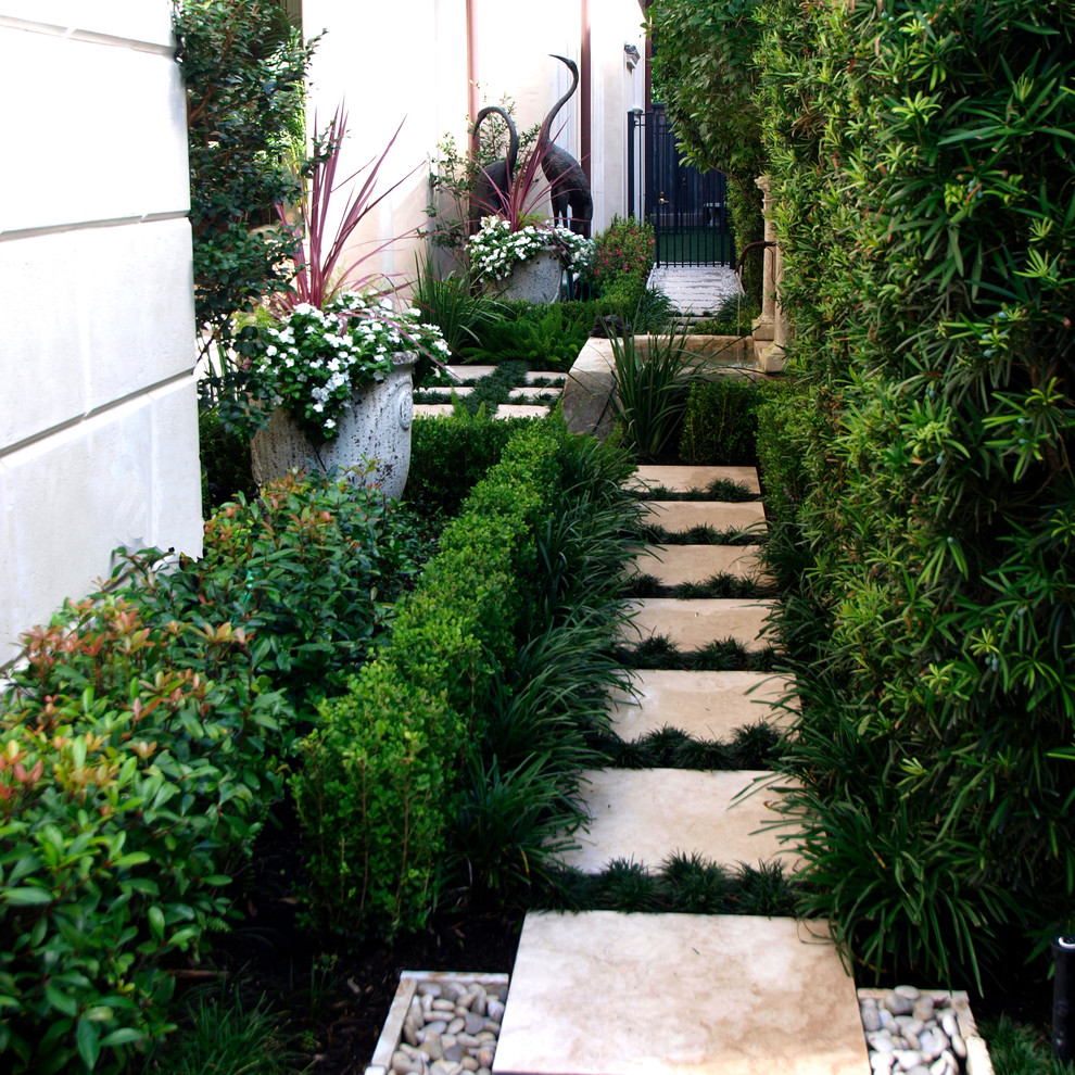 Inspiration for a mid-sized traditional partial sun side yard concrete paver landscaping in Houston.