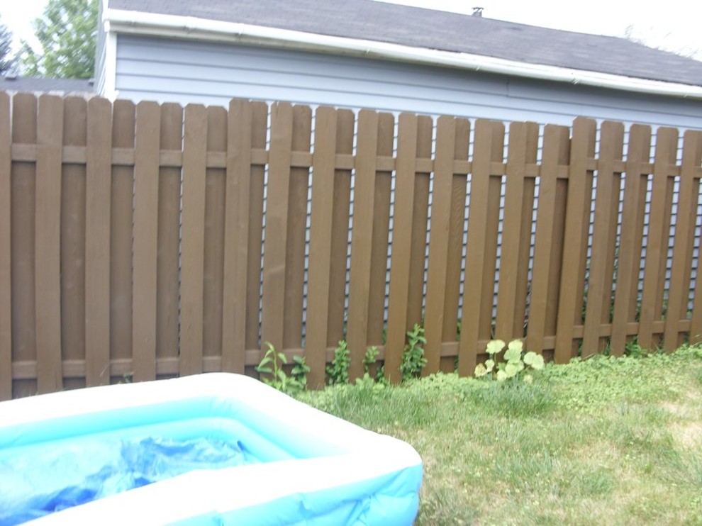 This is an example of a mid-sized full sun backyard retaining wall landscape in Milwaukee.