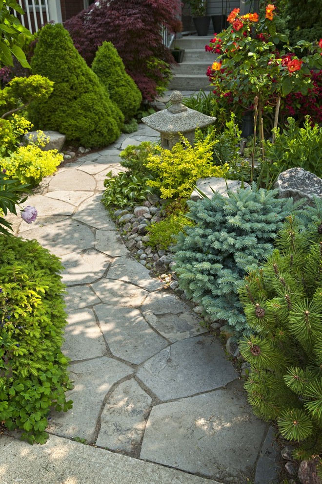 Photo of a large asian partial sun front yard stone garden path in Boston.