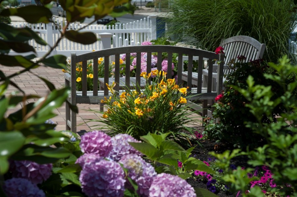 Design ideas for a mid-sized traditional partial sun backyard stone landscaping in New York.