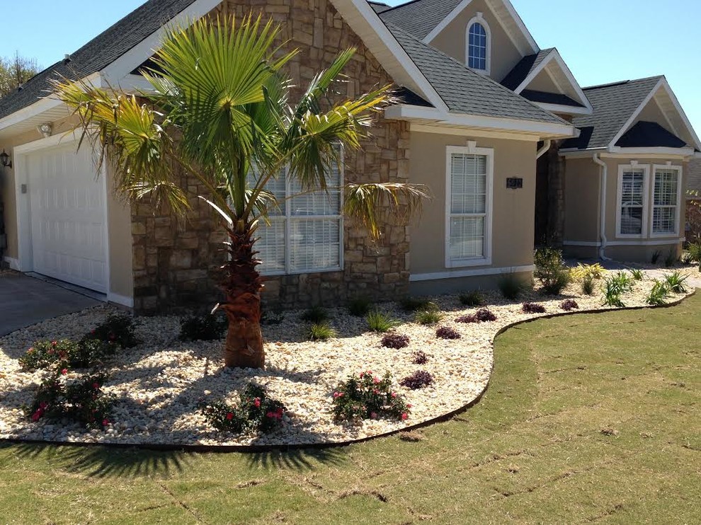 Photo of a large contemporary front xeriscape full sun garden for summer in Miami with gravel and a garden path.