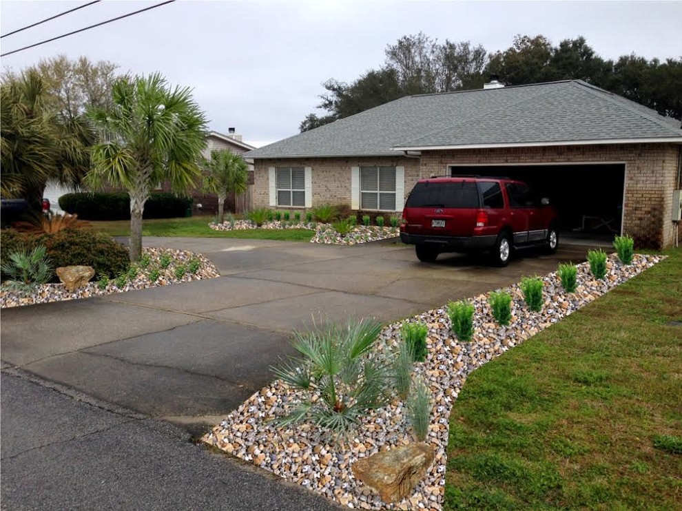 Photo of a large contemporary drought-tolerant and full sun front yard concrete paver landscaping in Miami.