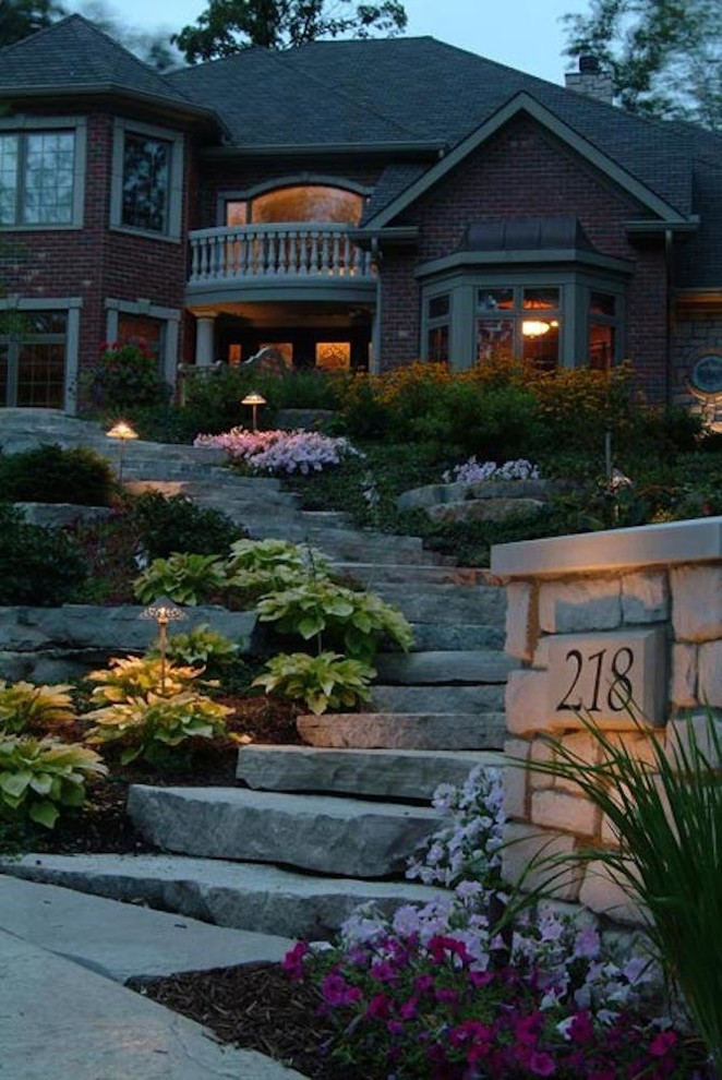 Design ideas for a large traditional partial sun front yard stone landscaping in Chicago.