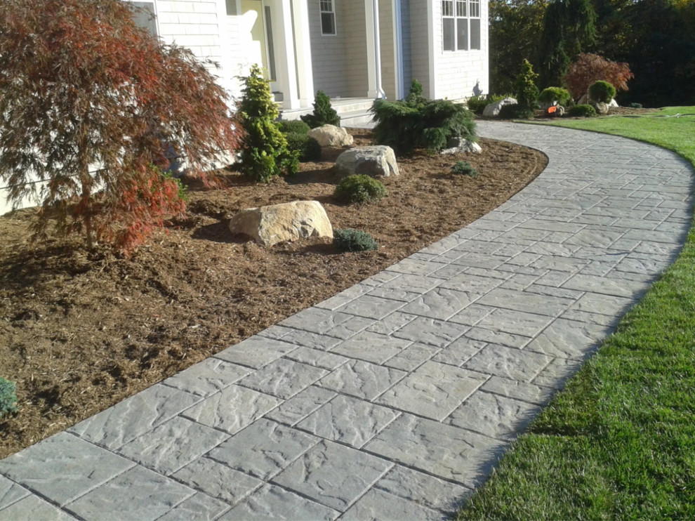 This is an example of a small transitional front yard concrete paver garden path in Bridgeport.