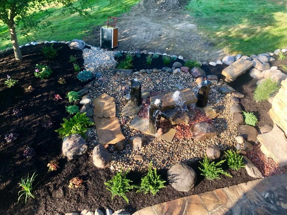 Design ideas for a large traditional partial sun backyard mulch water fountain landscape in Omaha.