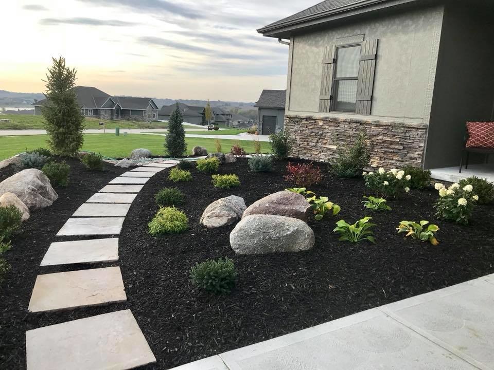 Large traditional back full sun garden in Omaha with a garden path and natural stone paving.