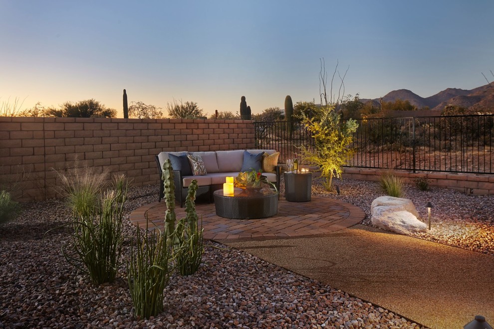 Photo of a large back partial sun garden in Phoenix with a garden path and concrete paving.