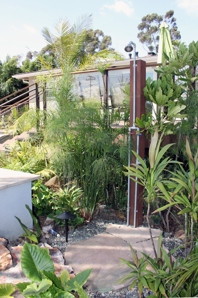 Esempio di un piccolo giardino tropicale esposto a mezz'ombra dietro casa con pavimentazioni in pietra naturale