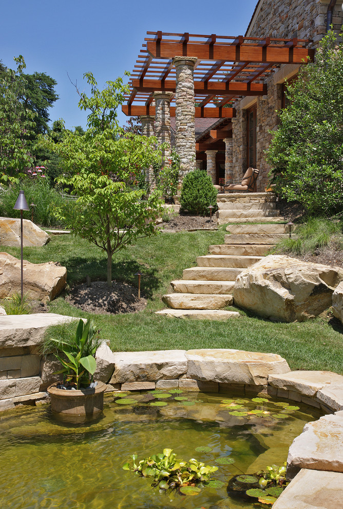 На фото: солнечный садовый фонтан на заднем дворе в средиземноморском стиле с хорошей освещенностью с