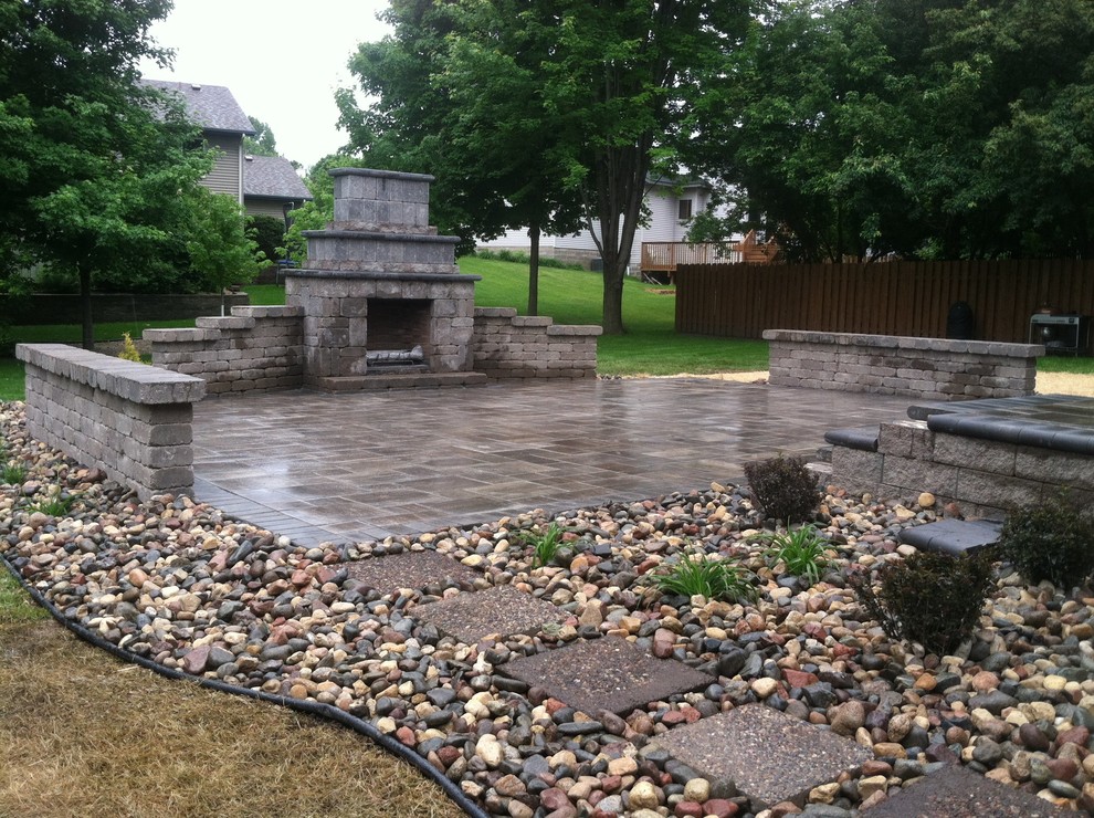 Inspiration for a large traditional back garden in Minneapolis with a fireplace and concrete paving.