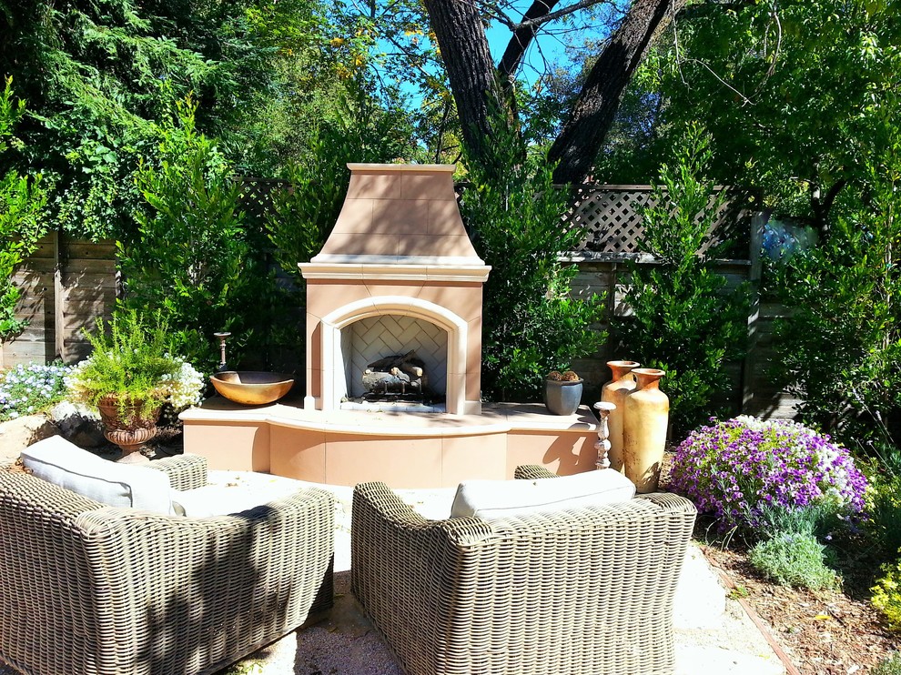 Mid-sized trendy backyard stone patio photo in San Francisco with a fire pit