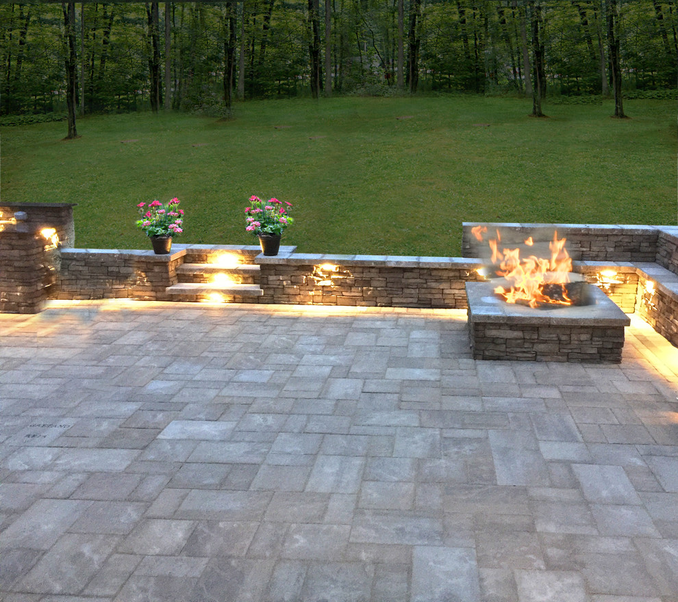 Large trendy backyard stone patio photo in New York