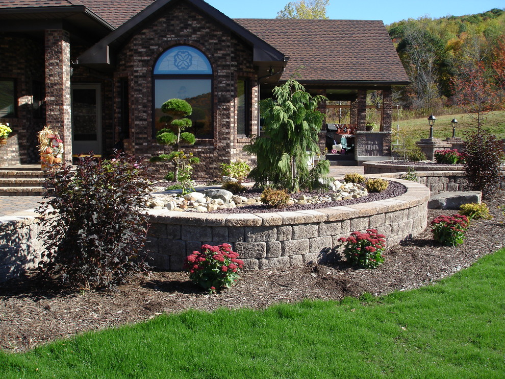 Photo of a mid-sized rustic full sun front yard concrete paver landscaping in Other.