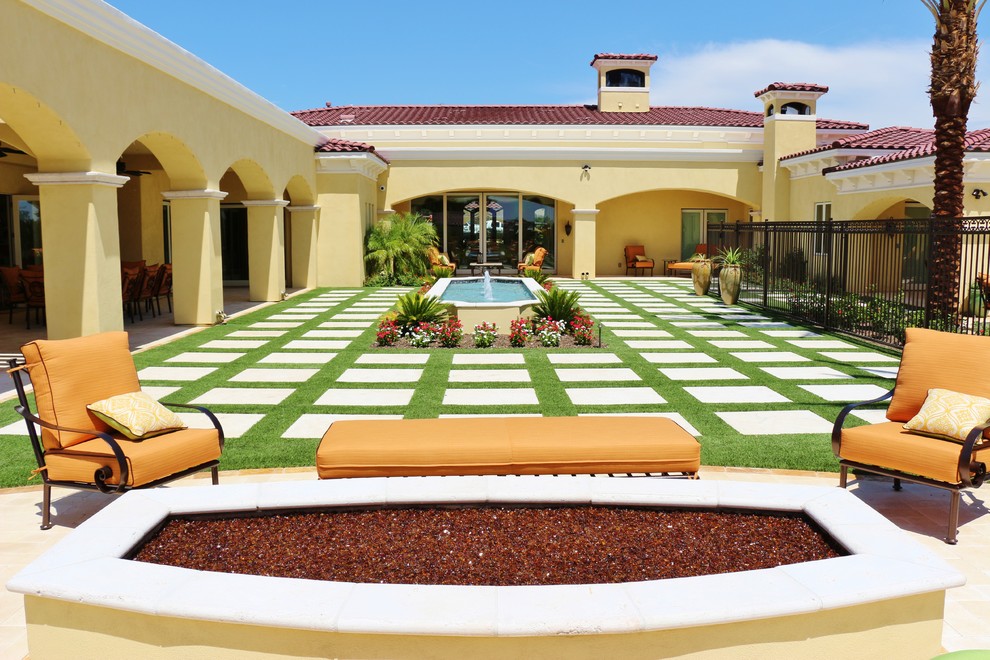 This is an example of a huge mediterranean full sun courtyard concrete paver landscaping in Phoenix with a fire pit.